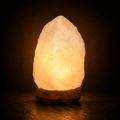 Pale Crystal Salt Lamp, 3-5kg – studio photo lit against a dark background