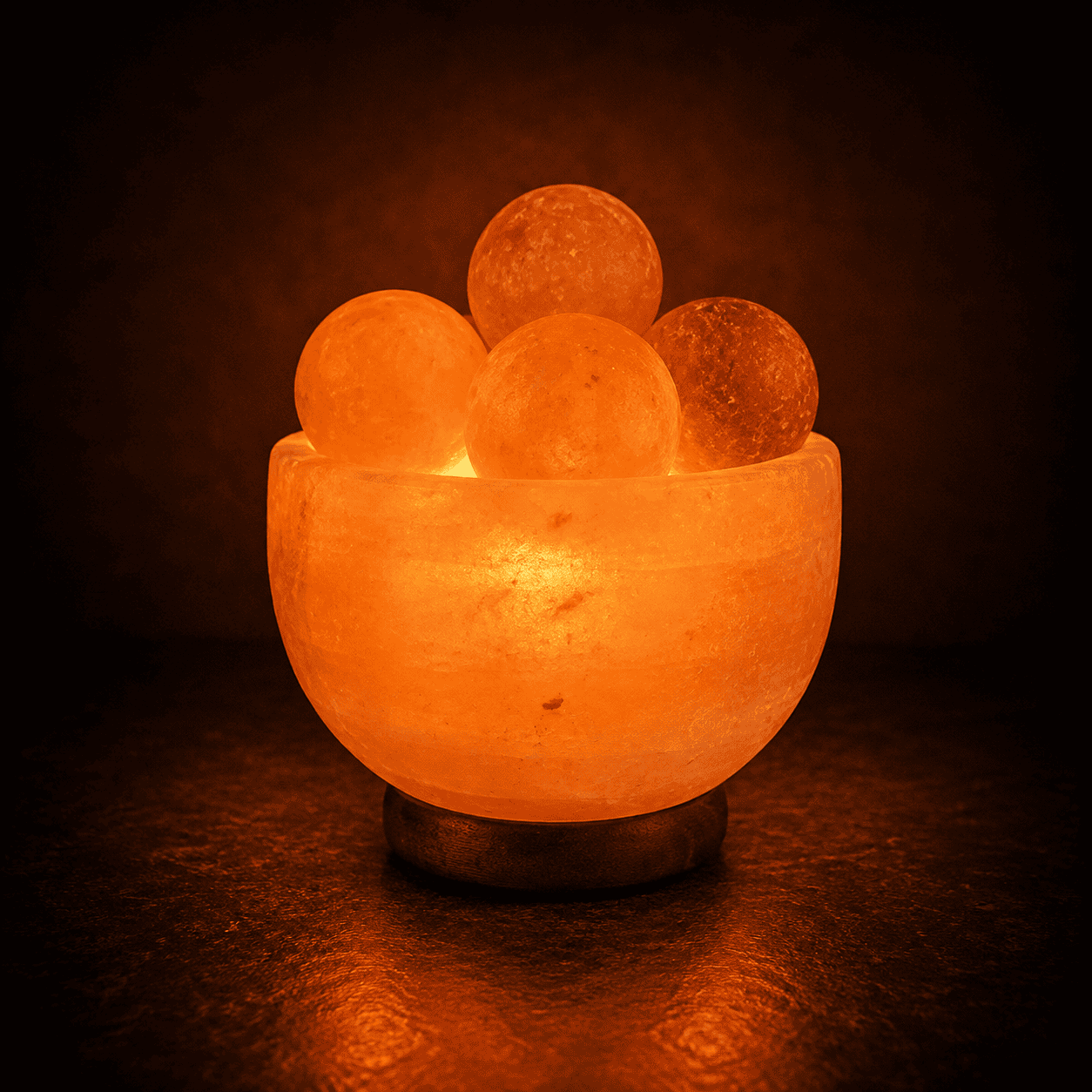 Salt Fire Bowl with Massage Balls – studio photo lit against a dark background