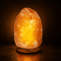 Himalayan Rock Salt Lamp, 1.5-2kg – studio photo lit against a dark background