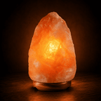 Himalayan Rock Salt Lamp, 5-7kg – studio photo lit against a dark background